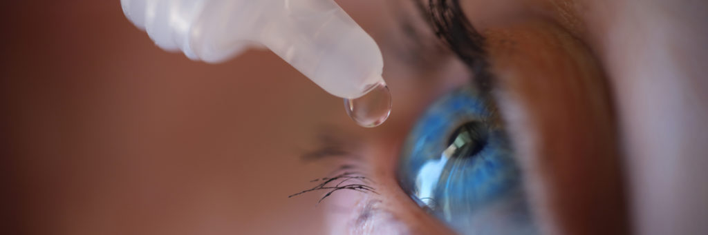woman applying eye drops e